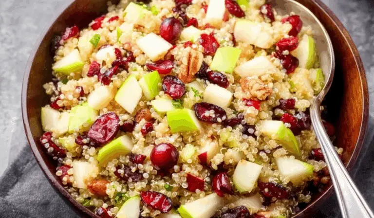Cranberry Apple Quinoa Salad with green apples, cranberries, and quinoa in a wooden bowl