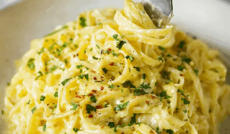 Creamy lemon pasta twirled on a fork with parsley garnish