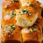 Garlic butter bread rolls close-up with golden crust and minced garlic topping