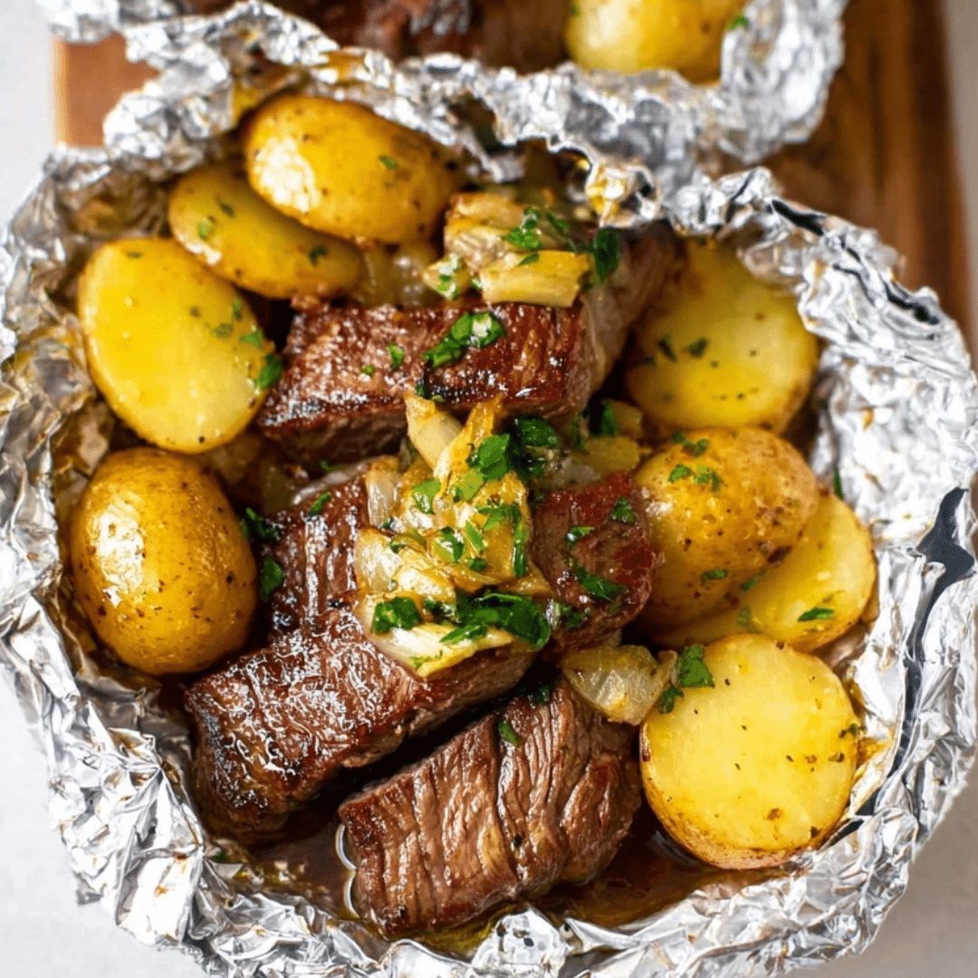 Garlic Butter Steak and Potato Foil Packets with baby potatoes and herbs