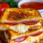 Pizza grilled cheese stacked sandwich with melted mozzarella and pepperoni