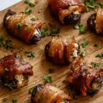 Bacon wrapped dates with goat cheese on white plate