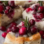 Brie cheese and cranberry Christmas wreath appetizer on holiday table