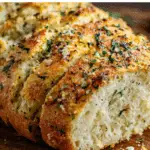 Garlic Parmesan Herb Bread on rustic board