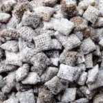 Puppy Chow Chex Mix in a bowl with powdered sugar
