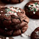 Peppermint Brownie Cookies stacked on rustic holiday table