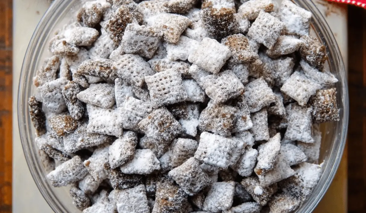Puppy Chow Chex Mix in a bowl with powdered sugar
