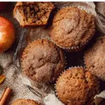 Apple Cider Spice Muffins fresh from the oven on a wooden table