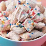 Birthday Cake Puppy Chow in a bowl with sprinkles