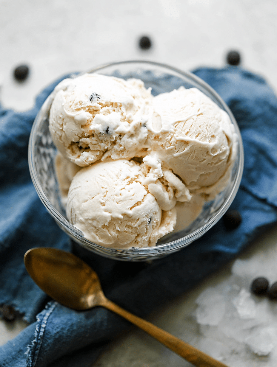 Bowl of cottage cheese ice cream with chocolate chips and fresh fruit toppings.
